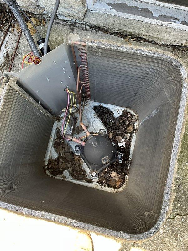 Performed comprehensive BFMA tune-up on residential air conditioning system. Inspected thermostat operation and confirmed proper temperature control settings at 72°F with system functioning in cooling mode. Conducted outdoor condensing unit maintenance, which included removing accumulated debris, leaves, and organic matter from unit base and around compressor. Inspected condenser coils, refrigerant lines, electrical connections, and capacitor. Verified all components operating within normal parameters upon completion of preventive maintenance service.