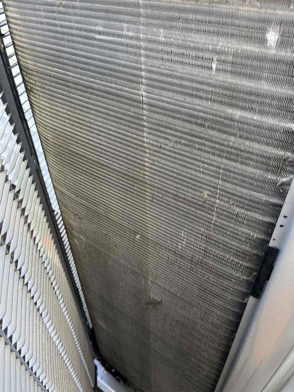 Completed comprehensive BFMA tune-up service on residential air conditioning system over 2 years old. Performed standard maintenance protocol including inspection of condenser coil, which revealed significant dirt and debris accumulation on lower fins requiring attention, and examination of evaporator coil showing dust buildup on filter media and fin surfaces. Cleaned and serviced all accessible components, verified system operation, and documented equipment condition through photographic records for maintenance history.