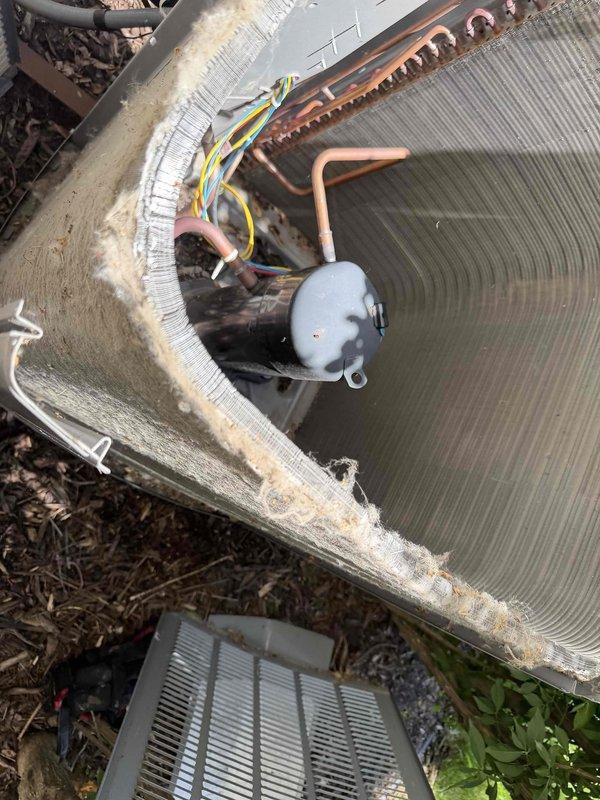 Completed comprehensive BFMA tune-up service on two residential air conditioning systems and dryer vent cleaning. Both AC units, aged 2-5+ years, showed significant accumulation of dirt and debris on condenser coils and fins, restricting airflow and reducing heat transfer efficiency. Performed thorough cleaning of condenser coils, removing heavy buildup of dust, organic matter, and environmental contaminants from aluminum fins and heat exchange surfaces. Inspected internal components including compressor, capacitor, and refrigerant lines; verified proper electrical connections and wiring integrity. Checked copper refrigerant line condition and noted minor oxidation consistent with normal outdoor exposure.

For dryer vent cleaning, utilized two-technician approach due to access constraints. Relocated washer and dryer units using moving blankets to protect flooring and facilitate access to rear connections. Accessed rooftop dryer vent termination using 10-foot ladder and climbing multipl