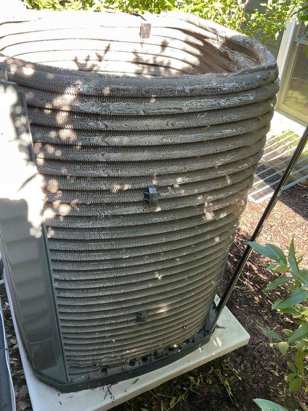 Completed comprehensive tune-up service on residential air conditioning system aged 10+ years. Performed thorough inspection of outdoor condenser unit, including cleaning of coil fins which showed significant dirt accumulation and debris buildup between fins. Inspected electrical components, capacitor, and wiring connections; verified all connections secure and functioning properly. Evaluated refrigerant lines and insulation wrapping for integrity. Unit operational and running within normal parameters upon completion of maintenance service.