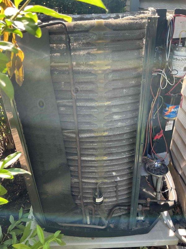 Completed comprehensive tune-up service on residential air conditioning system aged 10+ years. Performed thorough inspection of outdoor condenser unit, including cleaning of coil fins which showed significant dirt accumulation and debris buildup between fins. Inspected electrical components, capacitor, and wiring connections; verified all connections secure and functioning properly. Evaluated refrigerant lines and insulation wrapping for integrity. Unit operational and running within normal parameters upon completion of maintenance service.