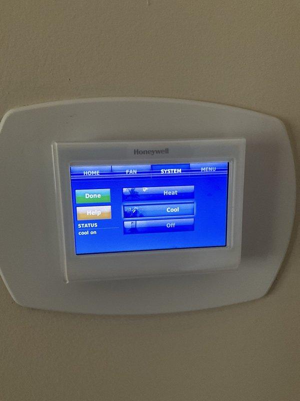 Completed comprehensive BFMA tune-up service on a 7-year-old residential air conditioning system. Performed full inspection of outdoor condenser unit, noting weathered fins with dirt accumulation that were cleaned during service. Verified proper operation of cooling system through Honeywell digital thermostat, confirmed "Cool On" status and proper system response. Inspected refrigerant lines, electrical connections, and mechanical components for proper operation and safety compliance. Unit operating within normal parameters upon completion of preventative maintenance service.