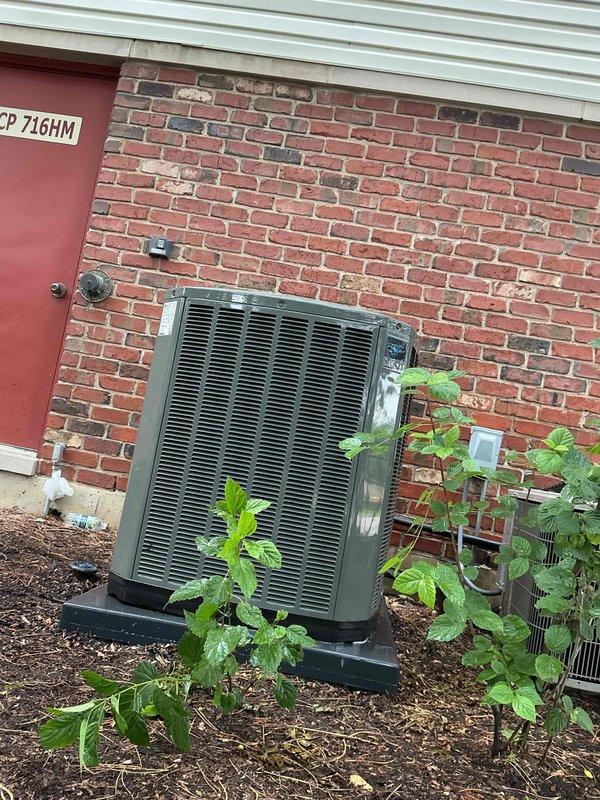 Completed comprehensive BFMA tune-up service on residential air conditioning system over 5 years old. Performed standard maintenance protocol including inspection of outdoor condenser unit, verification of thermostat operation displaying 77°F setpoint, and assessment of system components. Unit operational with no immediate issues identified; noted vegetation growth around condenser base requiring monitoring to ensure adequate airflow clearance.