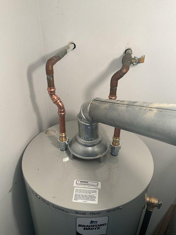 Completed installation of a 40-gallon residential tanked water heater as a first-time service call. Installed new unit with proper plumbing connections including copper supply lines, galvanized piping, gas line hookup with flexible yellow connector, and appropriate venting configuration. All connections secured with brass fittings and valves, drain valve installed, and unit positioned in utility room alongside existing HVAC equipment with adequate clearance for maintenance and code compliance.