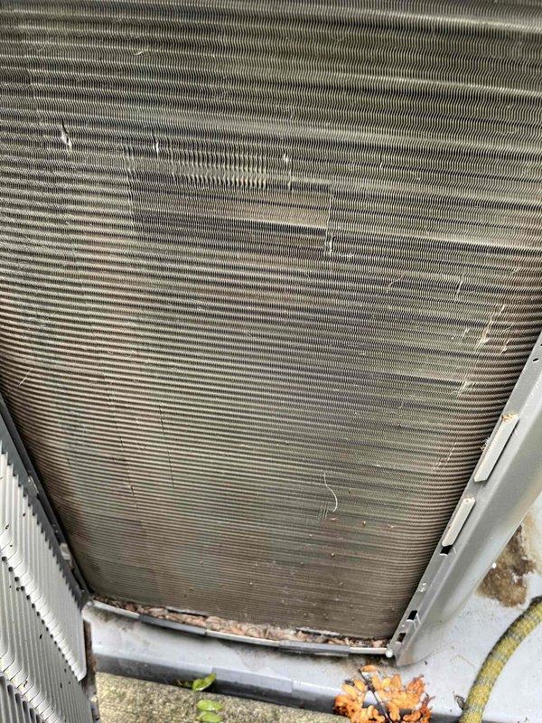 Completed comprehensive BFMA tune-up service on residential air conditioning system over one year old. Performed standard maintenance protocol including inspection of condenser coil unit, which showed moderate dirt accumulation and outdoor debris requiring attention, and verified air filter condition with clean FILTERBUY pleated media installed in system. All components inspected and system operational upon completion of tune-up procedures.