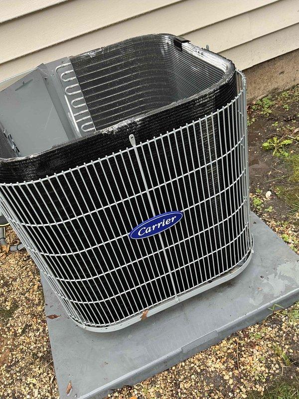Completed comprehensive BFMA tune-up service on a 5+ year old Carrier split-system air conditioning unit during afternoon appointment window. Performed standard preventive maintenance procedures including visual inspection of outdoor condensing unit, verified compressor operation, examined condenser coil condition and refrigerant line connections, and assessed overall system components for proper function and wear. Unit operational with no immediate deficiencies noted; documented equipment condition with photographic records for service history.