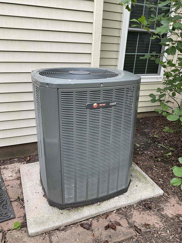 Completed comprehensive BFMA tune-up service on a 10+ year old Trane outdoor condensing unit. Performed full system inspection including visual assessment of cabinet condition, verified proper unit mounting and levelness on concrete pad, inspected electrical connections, checked refrigerant lines and insulation integrity, cleaned condenser coils, examined fan motor operation, and documented equipment condition with photographs. Unit operational and functioning within normal parameters upon service completion.
