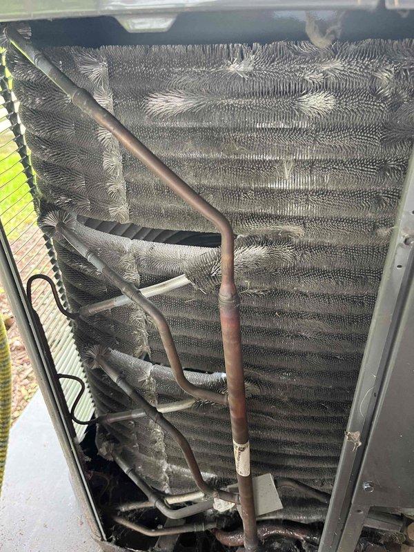 Completed comprehensive BFMA tune-up service on a 5-year-old air conditioning system, arriving after 1PM as requested. Performed thorough inspection of evaporator coil assembly, noting moderate dust and debris accumulation on fin surfaces and between coil rows. Assessed refrigerant lines showing normal oxidation consistent with equipment age, verified all copper connections, and documented unit condition through detailed photography. System components were inspected, cleaned, and confirmed operational within manufacturer specifications.