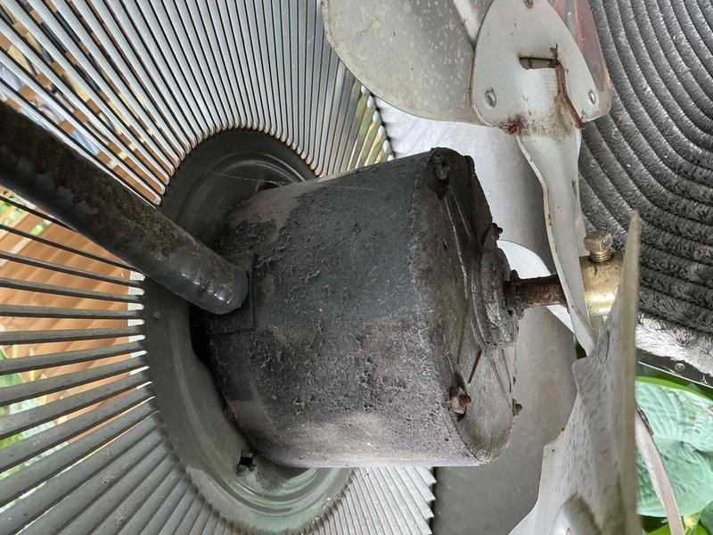 Completed comprehensive BFMA tune-up on 21-year-old air conditioning system. Performed thorough inspection and testing of outdoor condensing unit, which showed significant dust and debris accumulation on compressor motor and condenser coils due to age and environmental exposure. Conducted electrical diagnostics using digital multimeter to verify system performance, checked voltage readings, and confirmed proper operation of all major components despite visible weathering on unit housing and mounting brackets.