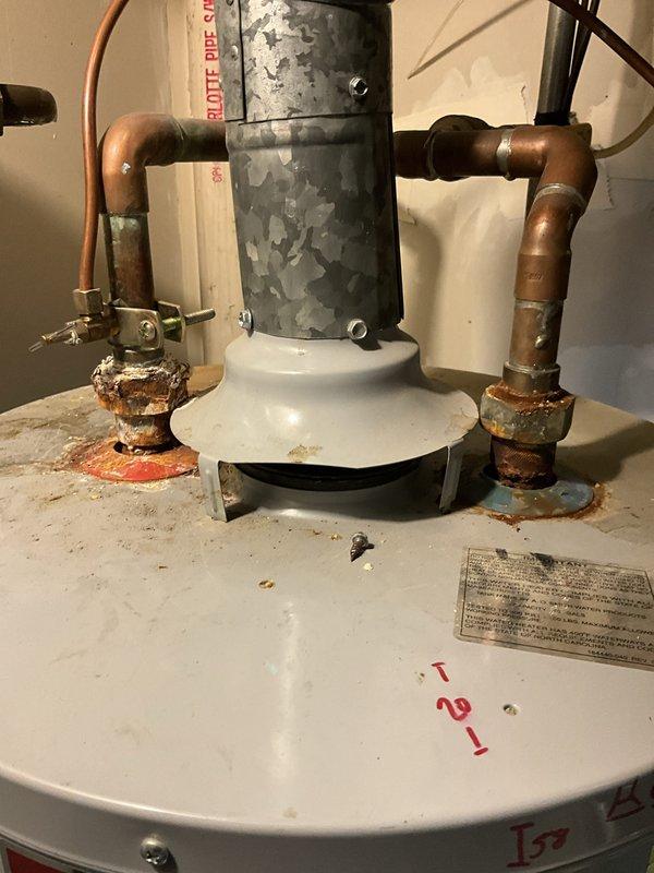 Completed comprehensive plumbing inspection and tune-up maintenance service at residential property. Inspected water heater installation, noting significant corrosion on copper pipe connections at both inlet and outlet ports, deteriorating flue pipe coating with extensive peeling and flaking, and visible rust accumulation at pipe-to-tank junction points. Documented existing conditions including thermal expansion device with dielectric union connections, brass shutoff valves, and overall water heater assembly showing age-related wear. Provided customer with photographic documentation and maintenance recommendations to address corrosion issues and extend equipment lifespan.