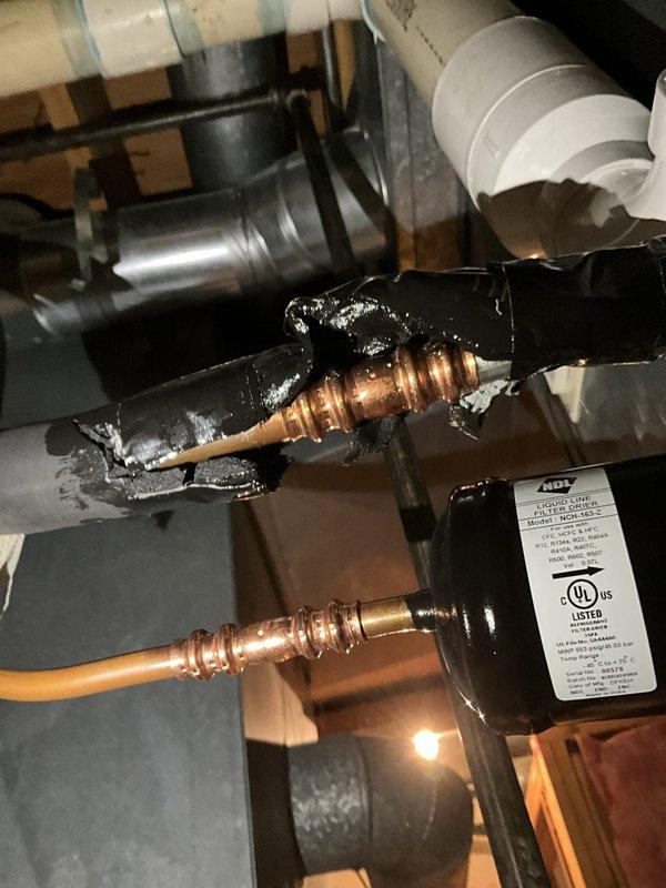 Responded to emergency no-cooling call with reports of chemical odor and occupants experiencing lightheadedness. Upon inspection, discovered severe refrigerant leak at evaporator coil connection with visible oil residue and corrosion on copper fittings. System was completely non-operational with potential refrigerant exposure in living space. Immediately shut down unit and red-tagged system due to health and safety concerns. Recommended occupants ventilate upper level thoroughly before re-entry. Advised that evaporator coil replacement and complete refrigerant recharge would be required, along with leak testing of entire system before restoration to service.