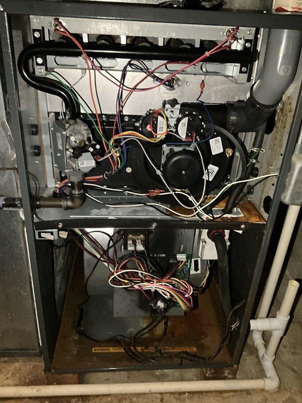 Responded to emergency no-cooling call with reports of chemical odor and occupants experiencing lightheadedness. Upon inspection, discovered severe refrigerant leak at evaporator coil connection with visible oil residue and corrosion on copper fittings. System was completely non-operational with potential refrigerant exposure in living space. Immediately shut down unit and red-tagged system due to health and safety concerns. Recommended occupants ventilate upper level thoroughly before re-entry. Advised that evaporator coil replacement and complete refrigerant recharge would be required, along with leak testing of entire system before restoration to service.