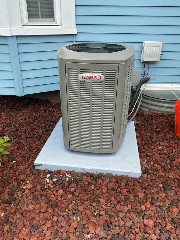 Completed comprehensive BFMA tune-up service on a Lennox residential air conditioning system located on exterior concrete pad. Performed standard maintenance protocol including system inspection, filter evaluation, electrical connection verification, and operational testing. Unit showed signs of normal wear with visible filter contamination requiring attention, and landscaping debris accumulation around condenser was noted during exterior cabinet inspection.