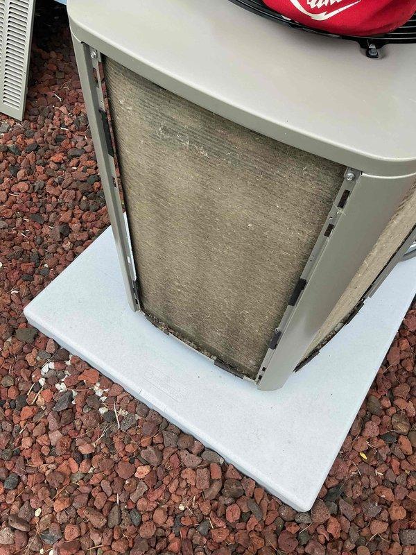 Completed comprehensive BFMA tune-up service on a Lennox residential air conditioning system located on exterior concrete pad. Performed standard maintenance protocol including system inspection, filter evaluation, electrical connection verification, and operational testing. Unit showed signs of normal wear with visible filter contamination requiring attention, and landscaping debris accumulation around condenser was noted during exterior cabinet inspection.