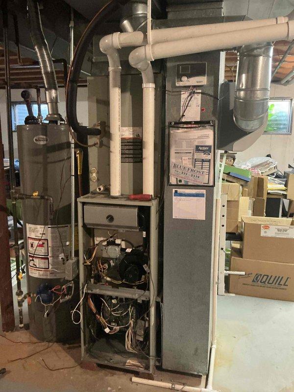 Completed full HVAC system replacement installing Lennox EL297UH09036CK furnace, ML 13KC1-048 condenser, and CK40CT-48C-71 coil in residential basement mechanical room. Removed existing 17.5" furnace and installed new 21" unit, accommodating size difference while maintaining proper clearances and connections. Reused existing 1" filter rack and reinstalled humidifier, thermostat, and outdoor humidity sensor from previous system.

Established all refrigerant line connections with proper insulation and fittings, installed new filter-drier in outdoor refrigerant circuit. Replaced outdoor whip and outdoor humidity sensor while retaining existing disconnect. Connected white PVC condensate piping with appropriate drainage routing. Verified proper ductwork connections to new furnace cabinet and secured all galvanized supply and return plenum attachments.

Completed all electrical connections including thermostat wiring, humidifier power, and outdoor unit hookup with 40A 2-pole breaker protecti