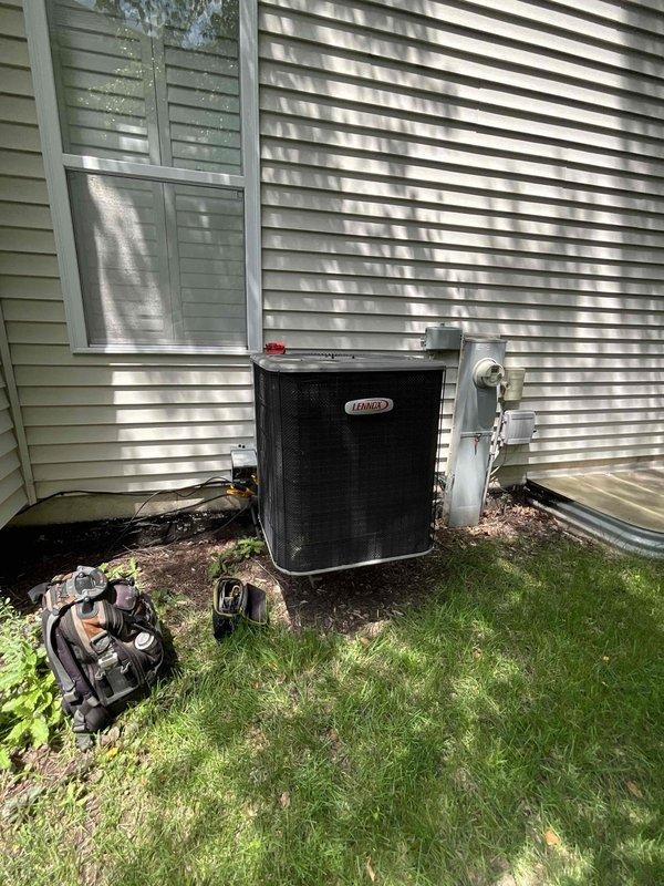 Completed full system HVAC estimate for residential property with existing Lennox equipment. Assessed basement-mounted vertical Lennox furnace with air handler/evaporator coil unit and outdoor Lennox condenser unit installed on exterior concrete pad against house foundation. Evaluated complete system including ductwork configuration with flexible ducting, PVC condensate drainage piping, refrigerant line sets running from outdoor unit to indoor components, and electrical connections. Documented current equipment specifications, installation configuration in mechanical room with concrete flooring and unfinished ceiling joists, and outdoor unit placement relative to building structure and landscaping. Provided comprehensive replacement options and upgrade recommendations based on home comfort requirements and existing system layout.