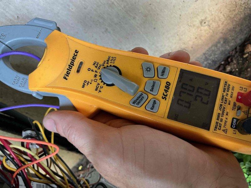 Performed comprehensive BFMA tune-up on 7-year-old residential air conditioning system. Removed condenser top cover for inspection, measured electrical amperage draw at 0.23 amps using clamp meter to verify compressor performance, and inspected refrigerant lines and electrical connections. System operating within normal parameters with all components functioning properly.