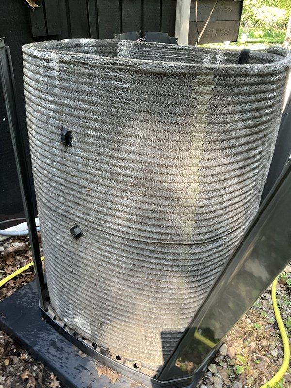 Completed comprehensive BFMA tune-up on 7+ year old air conditioning system during morning service window. Upon arrival, found outdoor condenser unit coils heavily clogged with debris, dust, and organic material causing significant airflow restriction and reduced system efficiency. Thoroughly cleaned condenser coils to restore proper airflow and heat transfer capability. Inspected electrical components within condenser compartment including capacitor and associated wiring connections. Verified all electrical connections were secure and capacitor showed proper markings and functionality. System restored to optimal operating condition with improved efficiency following coil cleaning and complete tune-up procedures.
