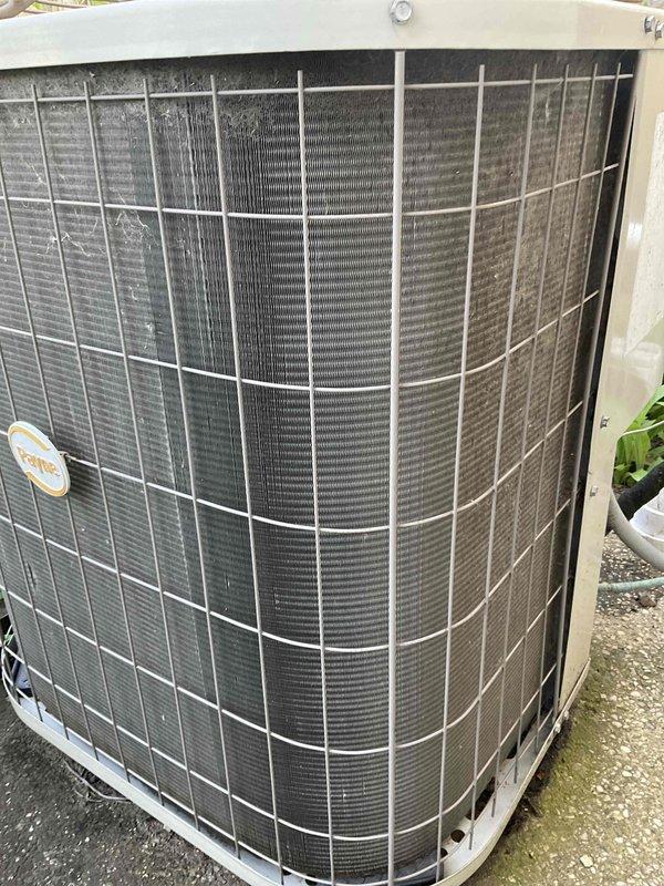 Completed preventative maintenance tune-up on residential outdoor air conditioning condenser unit per BFMA protocol. Performed comprehensive system inspection, noting condenser coils showing moderate dirt and debris accumulation between fins requiring attention. Unit operational with weathered exterior components including rust formation on fan guard, though system functioning within normal parameters. Customer scheduled for afternoon service window with advance notification as requested.