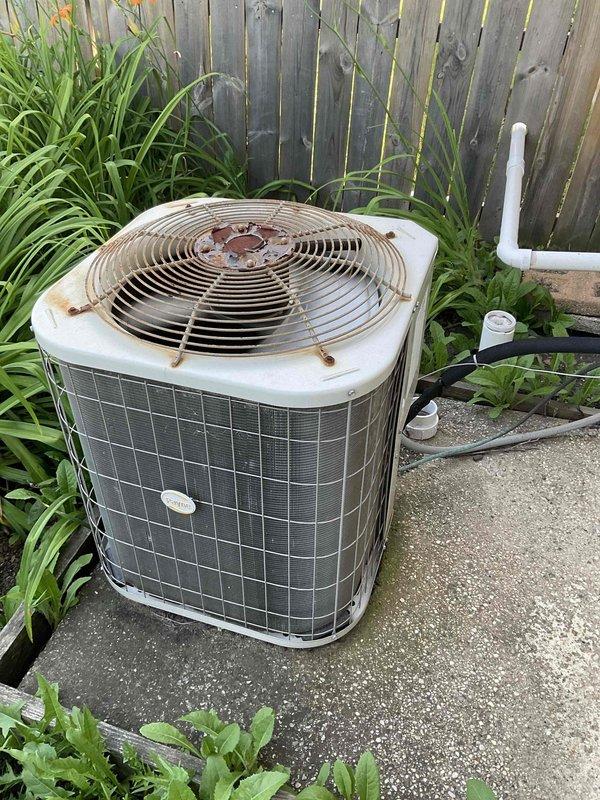 Completed preventative maintenance tune-up on residential outdoor air conditioning condenser unit per BFMA protocol. Performed comprehensive system inspection, noting condenser coils showing moderate dirt and debris accumulation between fins requiring attention. Unit operational with weathered exterior components including rust formation on fan guard, though system functioning within normal parameters. Customer scheduled for afternoon service window with advance notification as requested.
