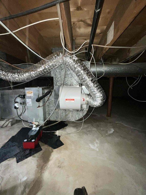 Responded to no cooling call with reported water leakage near evaporator coil area in crawl space. Upon inspection, found air handler unit with associated ductwork and condensate pump installation. Observed moisture issues around evaporator coil section with water not reaching recently installed condensate pump as described. Conducted thorough system evaluation including inspection of drain line routing, condensate pan condition, and insulation coverage on refrigerant lines and ductwork. No trouble found during diagnostic testing - system operating within normal parameters with proper airflow, adequate refrigerant charge, and functional condensate removal system at time of service call.