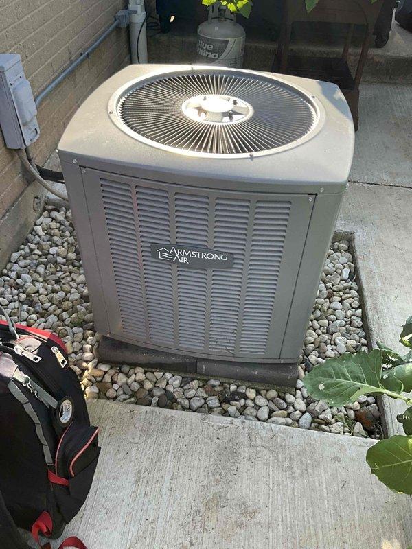 Completed comprehensive BFMA tune-up on Armstrong Air condensing unit located on exterior concrete pad with river rock landscaping. Performed full preventive maintenance inspection including electrical connections, refrigerant line assessment, condenser coil evaluation, and fan operation verification. Unit operating within normal parameters with all components functioning properly; system ready for cooling season.