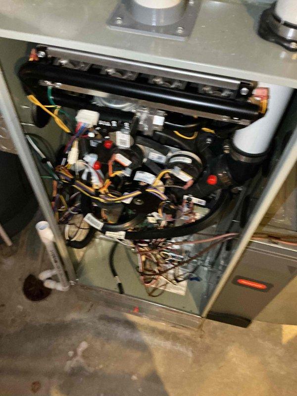 Completed comprehensive BFMA tune-up on 8-year-old HVAC system including full inspection of furnace electrical components, contactors, relays, control boards, and capacitor. Identified significant corrosion and rust accumulation on compressor capacitor terminals and housing, along with debris buildup around electrical connections. Cleaned and serviced all accessible components, tested system operation, and documented equipment condition for ongoing maintenance tracking.