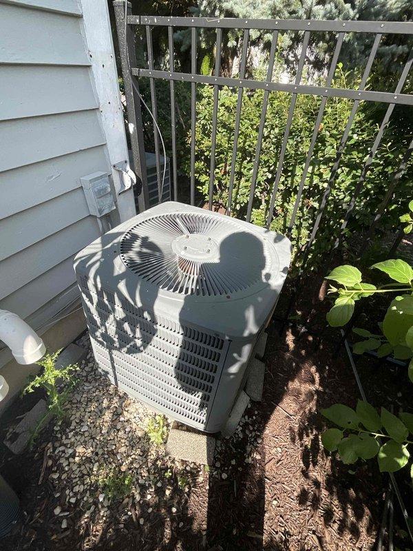 Conducted comprehensive site evaluation for full HVAC system replacement at residential property. Assessed existing outdoor condensing unit positioned on concrete pad with gravel surround against home exterior, noting equipment age and operational condition. Evaluated electrical service panel and circuit breaker configuration to determine capacity and compatibility requirements for new system installation. Documented current system specifications and site conditions through photographic documentation to develop accurate equipment sizing recommendations and installation scope for complete heating and cooling system replacement proposal.