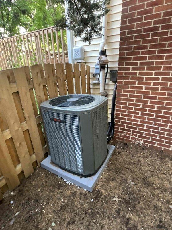 Completed comprehensive BFMA tune-up on residential central air conditioning system located in side yard between brick wall and wooden fence. Performed standard maintenance protocol including inspection of outdoor condensing unit with louvered metal grille, verification of proper installation on concrete pad, examination of refrigerant lines with white insulation running to indoor components, and detailed assessment of evaporator coil assembly with horizontal aluminum fins and copper refrigeration circuit. System evaluated for proper operation with all components found in functional condition following tune-up procedures.