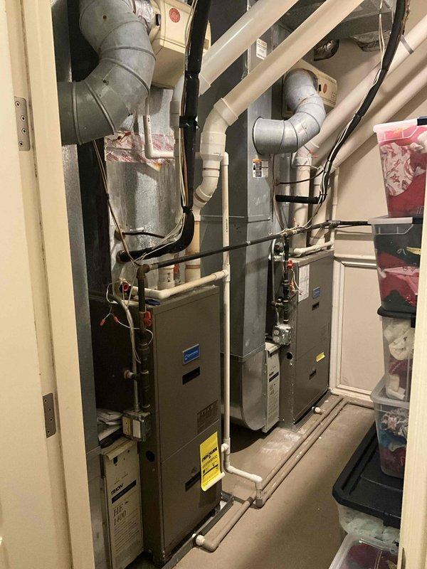 Responded to no cooling complaint on second and third floors with significant temperature differential (thermostat set to 65°F but reading 78-80°F). Performed diagnostic evaluation of multi-zone HVAC system consisting of dual furnace units in mechanical room and three outdoor condensing units. Assessed system configuration, zoning controls, refrigerant lines, electrical connections, and ductwork distribution to identify cause of inadequate cooling in upper levels and provided full system replacement estimate.
