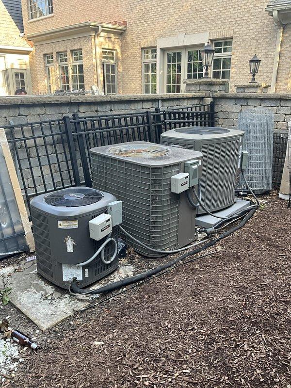 Responded to no cooling complaint on second and third floors with thermostat set to 65°F but showing 78°F and 80°F respectively. Upon arrival, found multiple outdoor condensing units installed on rooftop area. Performed diagnostic evaluation of the multi-zone HVAC system to identify cause of inadequate cooling in upper levels and documented equipment conditions with photos for service records.