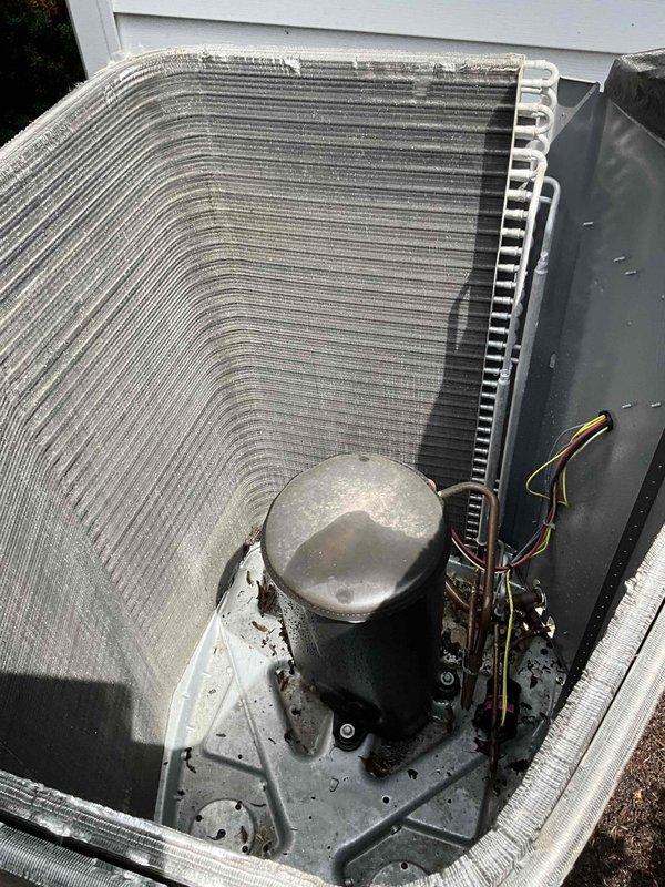 Completed comprehensive BFMA tune-up on 3-year-old air conditioning system. Inspected outdoor condenser unit and found heat exchanger coils heavily contaminated with dirt, dust, and debris accumulation across fin surfaces, which reduces airflow and system efficiency. Cleaned condenser coils thoroughly to restore proper heat transfer capability. Inspected indoor air handler and verified air filter condition—pleated filter appeared serviceable. Checked refrigerant lines, electrical connections, and compressor operation. System tested and operating within normal parameters following maintenance completion.