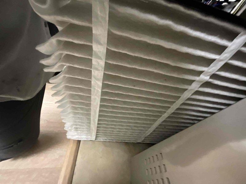Completed comprehensive BFMA tune-up on 3-year-old air conditioning system. Inspected outdoor condenser unit and found heat exchanger coils heavily contaminated with dirt, dust, and debris accumulation across fin surfaces, which reduces airflow and system efficiency. Cleaned condenser coils thoroughly to restore proper heat transfer capability. Inspected indoor air handler and verified air filter condition—pleated filter appeared serviceable. Checked refrigerant lines, electrical connections, and compressor operation. System tested and operating within normal parameters following maintenance completion.