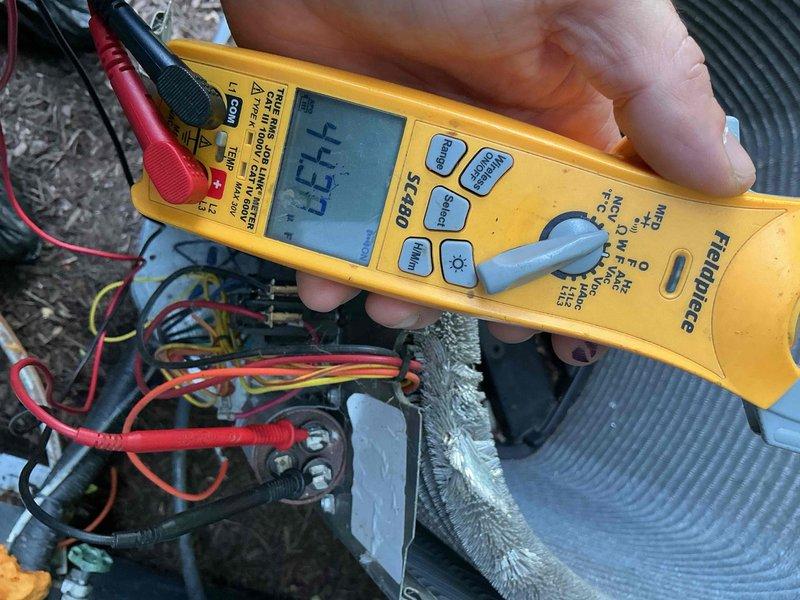 Completed comprehensive BFMA tune-up service on residential HVAC system with equipment age 5+ years. Performed thorough inspection and testing of air conditioning unit, including electrical diagnostics using multimeter to verify proper voltage readings at contactor assembly and terminal connections. Verified thermostat operation showing system cooling to 71°F setpoint with indoor humidity at 46%, confirmed proper communication between thermostat and equipment, and replaced air filters per maintenance protocol.