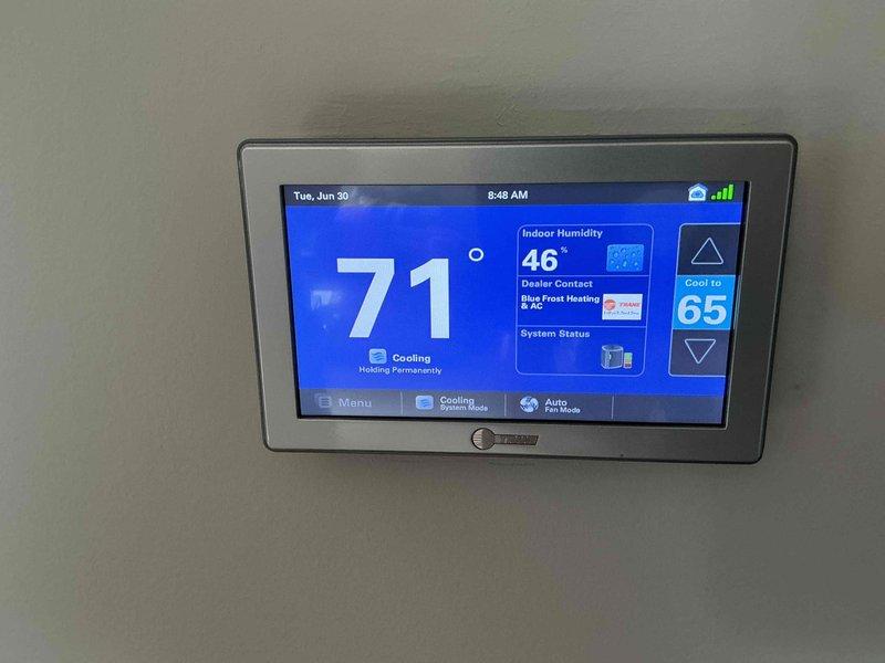 Completed comprehensive BFMA tune-up service on residential HVAC system with equipment age 5+ years. Performed thorough inspection and testing of air conditioning unit, including electrical diagnostics using multimeter to verify proper voltage readings at contactor assembly and terminal connections. Verified thermostat operation showing system cooling to 71°F setpoint with indoor humidity at 46%, confirmed proper communication between thermostat and equipment, and replaced air filters per maintenance protocol.