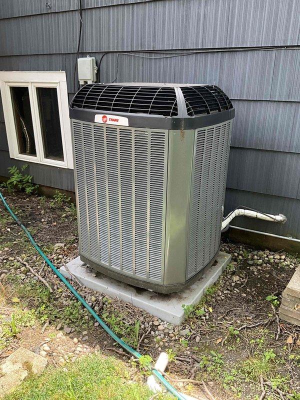 Completed comprehensive BFMA tune-up service on a 2-year-old Trane air conditioning system. Performed full system inspection, cleaned condenser coils which showed moderate dirt accumulation and weathering, checked refrigerant levels, tested electrical connections and controls, verified proper airflow through the unit, and ensured all components were operating within manufacturer specifications. Unit is functioning properly with no issues identified during the maintenance service.