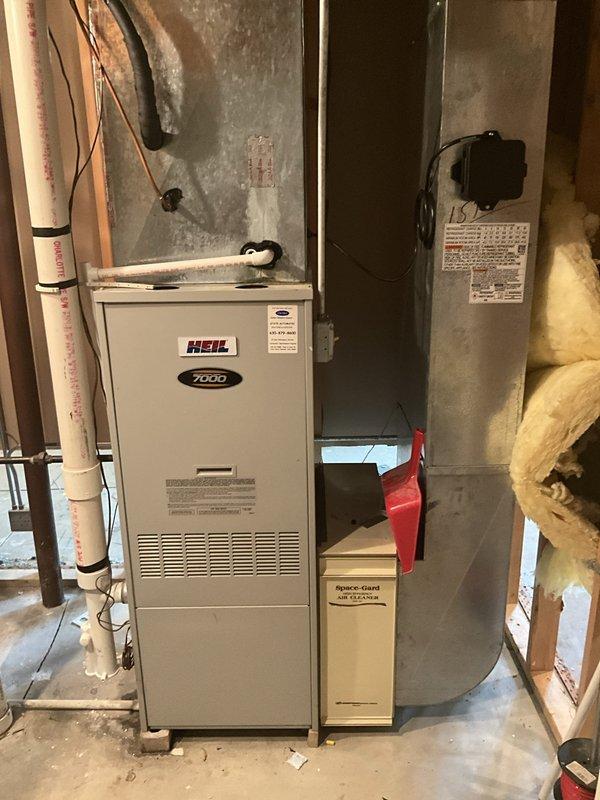 Responded to service call for furnace inspection following water damage incident. Performed diagnostic evaluation on Heil 7000 series furnace unit to assess operational status and determine extent of water-related damage for insurance documentation purposes. Conducted thorough visual inspection of internal components, including blower assembly, control board, wiring connections, and burner compartment. Documented current condition of unit with photographic evidence showing dust accumulation, exposed mechanical components, and overall system configuration. Inspected PVC condensate drainage lines and surrounding ductwork for signs of water intrusion or moisture damage that could affect system performance or safety.