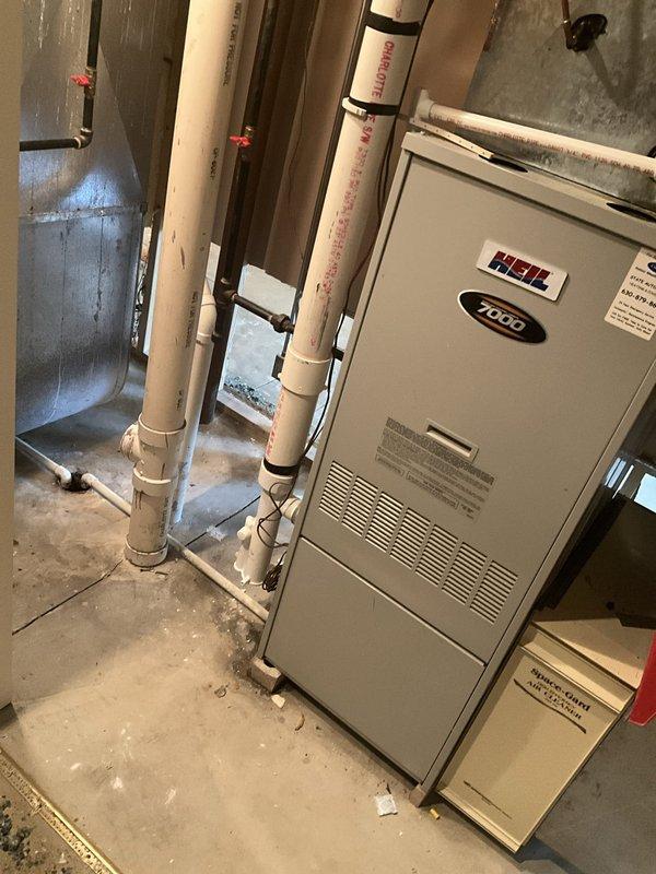 Conducted comprehensive sales estimate consultation for furnace replacement in basement utility area. Evaluated existing Heil 2000 series furnace unit, assessed surrounding PVC venting and drainage systems, and inspected sheet metal ductwork configuration. Documented equipment condition, utility space layout, and mechanical system arrangement to develop appropriate replacement recommendations and ensure proper sizing for optimal home comfort.