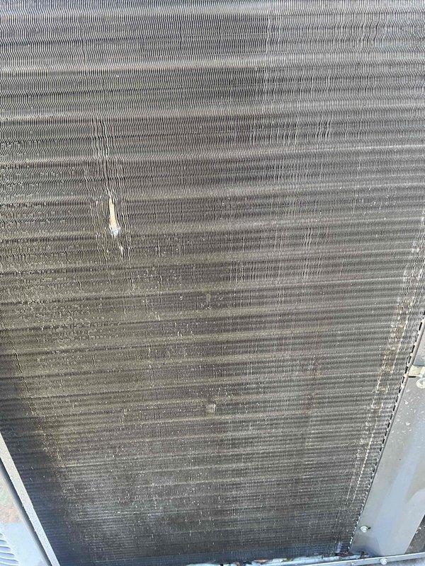 Completed BFMA AC tune-up service on residential air conditioning system. Performed comprehensive inspection of condenser unit, noting significant accumulation of dust and debris on coil fins which was reducing system efficiency. Documented coil condition with photos showing buildup on aluminum fins and heat exchanger surfaces prior to cleaning and system evaluation.