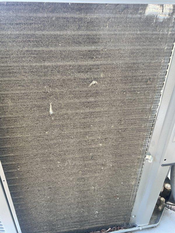Completed BFMA AC tune-up service on residential air conditioning system. Performed comprehensive inspection of condenser unit, noting significant accumulation of dust and debris on coil fins which was reducing system efficiency. Documented coil condition with photos showing buildup on aluminum fins and heat exchanger surfaces prior to cleaning and system evaluation.