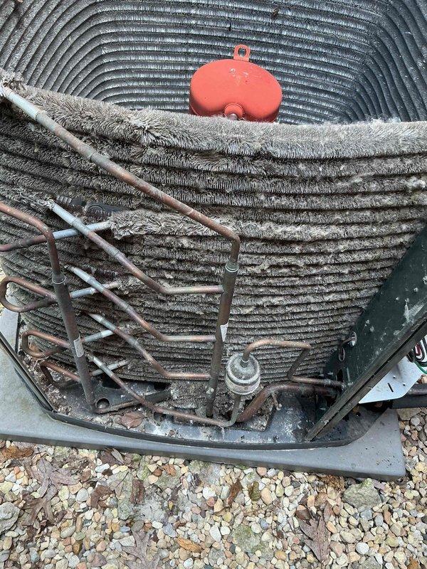 Completed comprehensive BFMA tune-up on 11-year-old air conditioning system. Upon arrival, discovered condenser coils heavily clogged with dirt, dust, lint, and debris accumulation, significantly restricting airflow and reducing system efficiency. Thoroughly cleaned condenser coils using appropriate methods to remove all accumulated contaminants from fins and heat exchanger surfaces. Performed complete system inspection including refrigerant lines, electrical connections, and capacitor. Verified proper operation of all components and restored unit to optimal performance specifications.