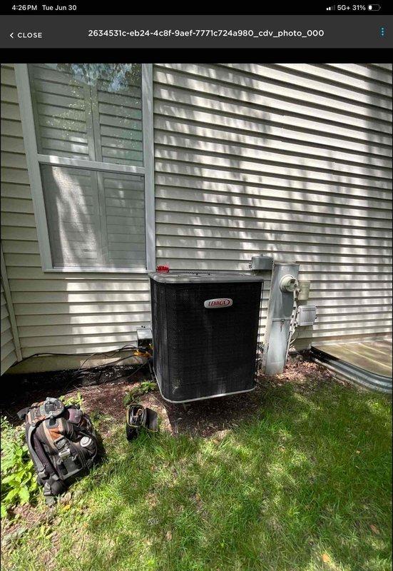 Completed installation of Lennox ML13KC1 1-ton air conditioning system with P200 cased evaporator coil and Lennox control module. The outdoor condensing unit was positioned on a ground-level pad adjacent to the electrical meter on the side of the residence, with the indoor cased coil integrated above the existing Lennox furnace in the basement mechanical room. All refrigerant lines, electrical connections, and condensate drainage were properly installed and tested to ensure system functionality and compliance with manufacturer specifications.