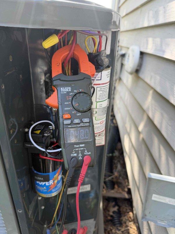 Completed installation of hard start kit, condenser fan motor replacement, and AC system renewal service on residential outdoor condensing unit. Performed electrical diagnostics with digital clamp meter to verify proper amperage draw and confirm system operation. All components tested and unit returned to normal cooling operation with improved starting efficiency and airflow performance.