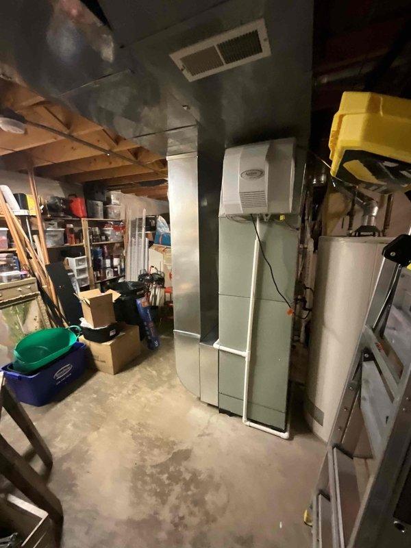 Completed comprehensive BFMA tune-up service on 4+ year old air conditioning system. Performed full system inspection including condenser unit evaluation, replaced air filter, and assessed indoor air handler components in basement mechanical room. Unit showed signs of normal wear with debris accumulation on condenser fan assembly; cleaned and verified proper operation of all mechanical and electrical components to ensure optimal system performance for the cooling season.