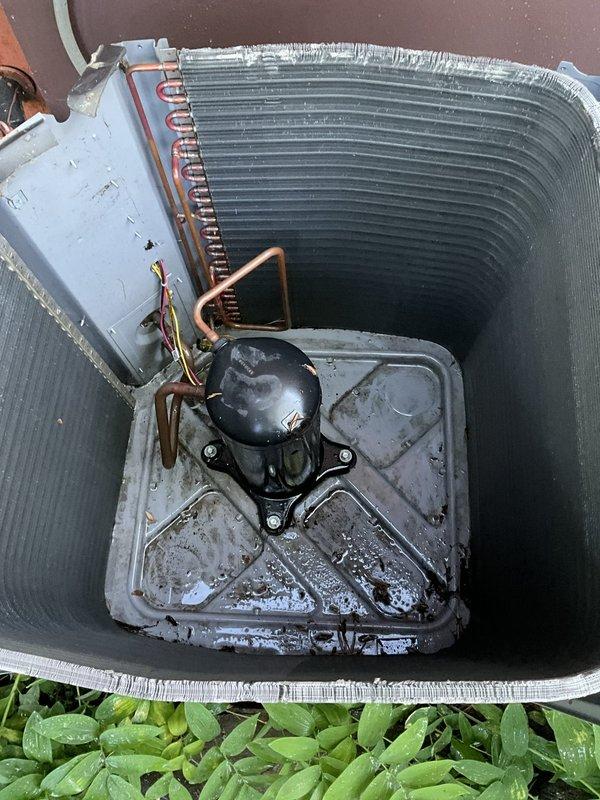 Completed comprehensive BFMA tune-up on 8+ year old outdoor air conditioning unit. Performed thorough inspection of all major components including compressor, condenser coil assembly, refrigerant lines, and electrical connections. Cleaned heavily soiled base pan which contained significant accumulation of dirt, leaves, and organic debris. Inspected cylindrical finned condenser coil which showed dirt and debris buildup on fin surfaces. Verified proper operation of compressor, checked copper refrigerant line connections, and inspected electrical junction box and wiring. System operational upon completion of maintenance service.