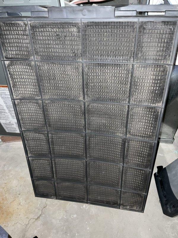Completed comprehensive BFMA tune-up service on two aging air conditioning systems, both over 15 years old. Performed full maintenance inspection of outdoor condenser unit, including coil cleaning and electrical component verification, with disconnect box confirmed operational. Inspected and documented condition of indoor air handling unit with heavily soiled 24-panel mesh air filter showing significant dust and debris accumulation, indicating need for replacement to maintain proper airflow and system efficiency.