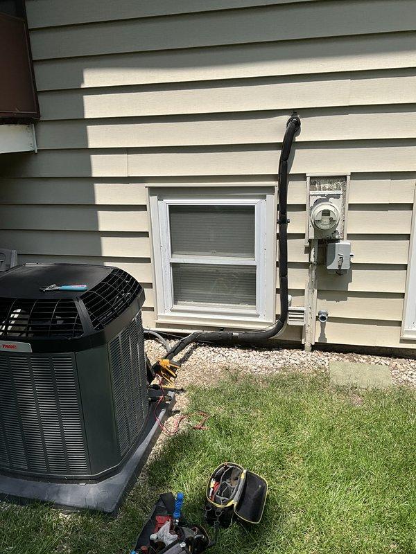 Responded to after-hours emergency service call for water leak from condensate pump on 16-17 year old residential HVAC system. Upon arrival, inspected outdoor condensing unit and condensate drainage system at foundation level. Located source of water leak at condensate pump assembly. Cleared blocked condensate drain line and verified proper drainage flow from evaporator coil. Tested condensate pump operation and confirmed pump was cycling correctly and discharging water appropriately through exterior drain lines. Inspected all accessible condensate piping, mounting brackets, and discharge points along building foundation. System restored to normal operation with no further water leakage observed during testing cycle.