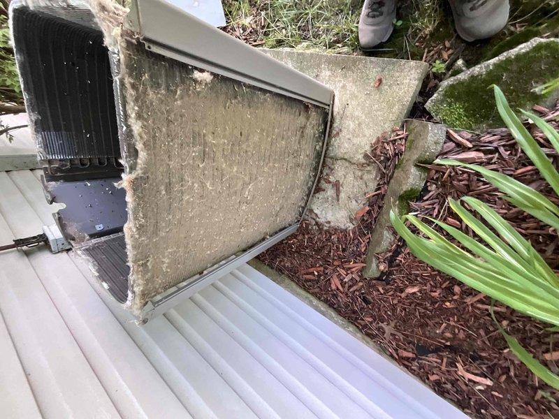 Completed comprehensive BFMA tune-up on residential outdoor AC condenser unit aged 1+ years. Upon inspection, discovered heavily clogged filter with significant accumulation of dust, debris, and organic matter restricting airflow. Cleaned condenser coils, removed debris from unit top and surrounding area, serviced filter, and verified system operation. Unit restored to proper working condition with improved airflow efficiency.