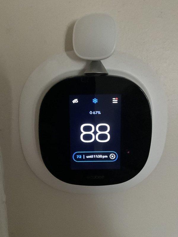 Responded to no cooling condition affecting upstairs zone while remainder of home maintained proper temperature. Inspected American Standard Silver series outdoor condensing unit (Model 4A7A3018H1100NA, 208/230V) and verified unit operational status. Reviewed ecobee smart thermostat settings displaying 88°F ambient temperature with setpoint of 72°F and 67% humidity reading. Diagnosed zoning system issue preventing adequate airflow and cooling delivery to upper level. Restored proper system operation and verified temperature recovery at thermostat.