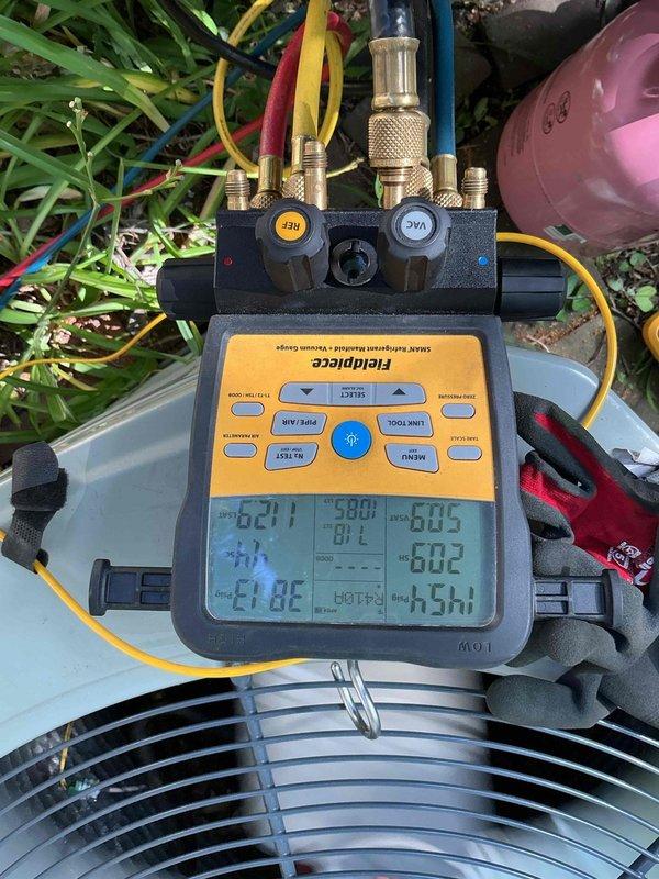 Responded to service call for bubbling water coming from drain pipe. Upon arrival, performed diagnostic evaluation of air conditioning system. Connected manifold gauges to measure system pressures and temperatures. Discovered evaporator coil heavily frosted over, indicating restricted airflow or low refrigerant charge causing excessive condensation and drainage issues. Tested system operation and documented conditions with photos showing frost accumulation on copper refrigerant lines and operating pressures. Identified cause of water drainage problem as direct result of frozen evaporator coil condition requiring further service to address underlying airflow restriction or refrigerant charge issue.
